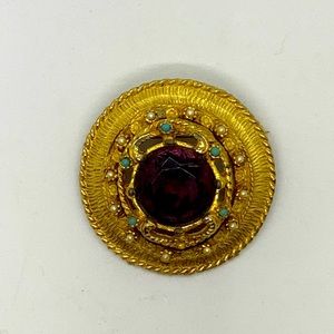 Guilted costume brooch with purple center gem